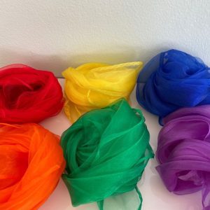 Six brightly colored sheer dancing scarves in red, yellow, blue, orange, green, and purple, rolled into distinct bundles