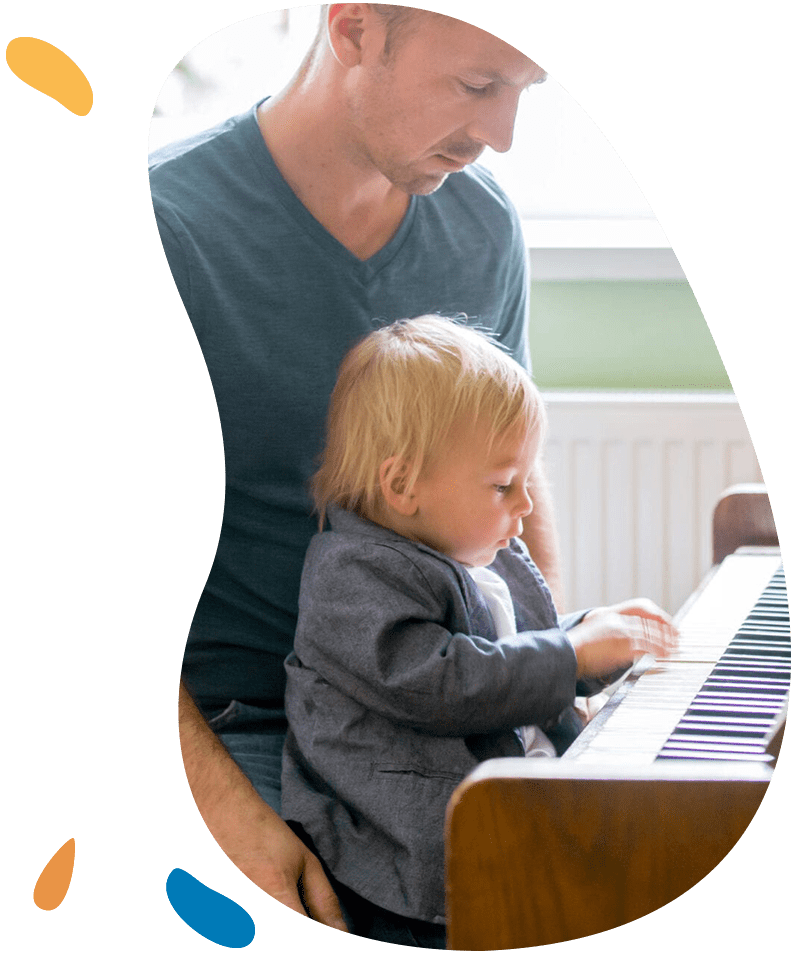Small toddler boy enjoys playing piano for the first time