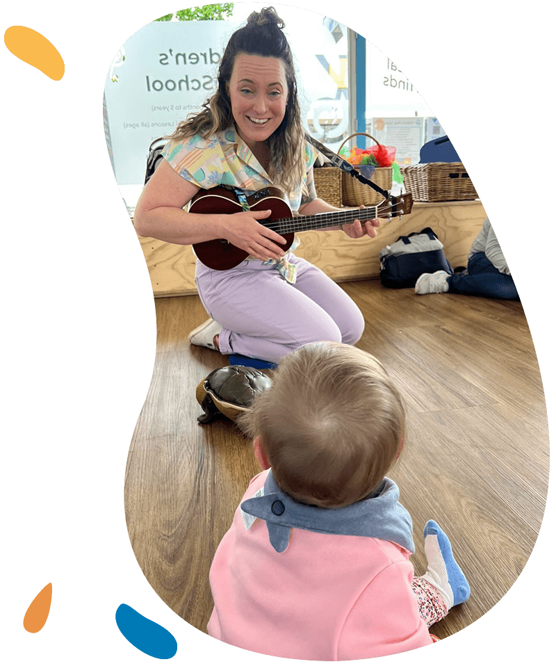 Tanya playing ukulele singing to baby